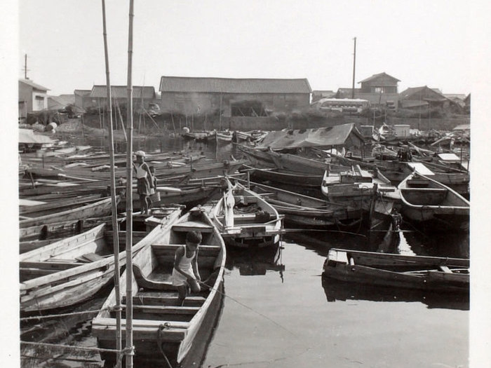 Des enfants jouant sur les barques dans un petit port