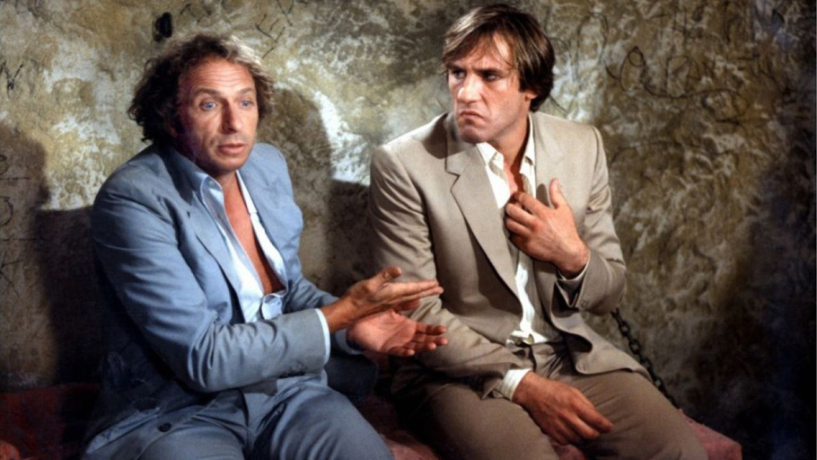 Pierre Richard et Gérard Depardieu dans La Chèvre Pierre Richard et Gérard Depardieu assis côte à côte dans une cellule dans La Chèvre