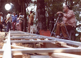 Roberto Rossellini assis derrire le Pancinor sur le tournage des Actes des aptres, 1968